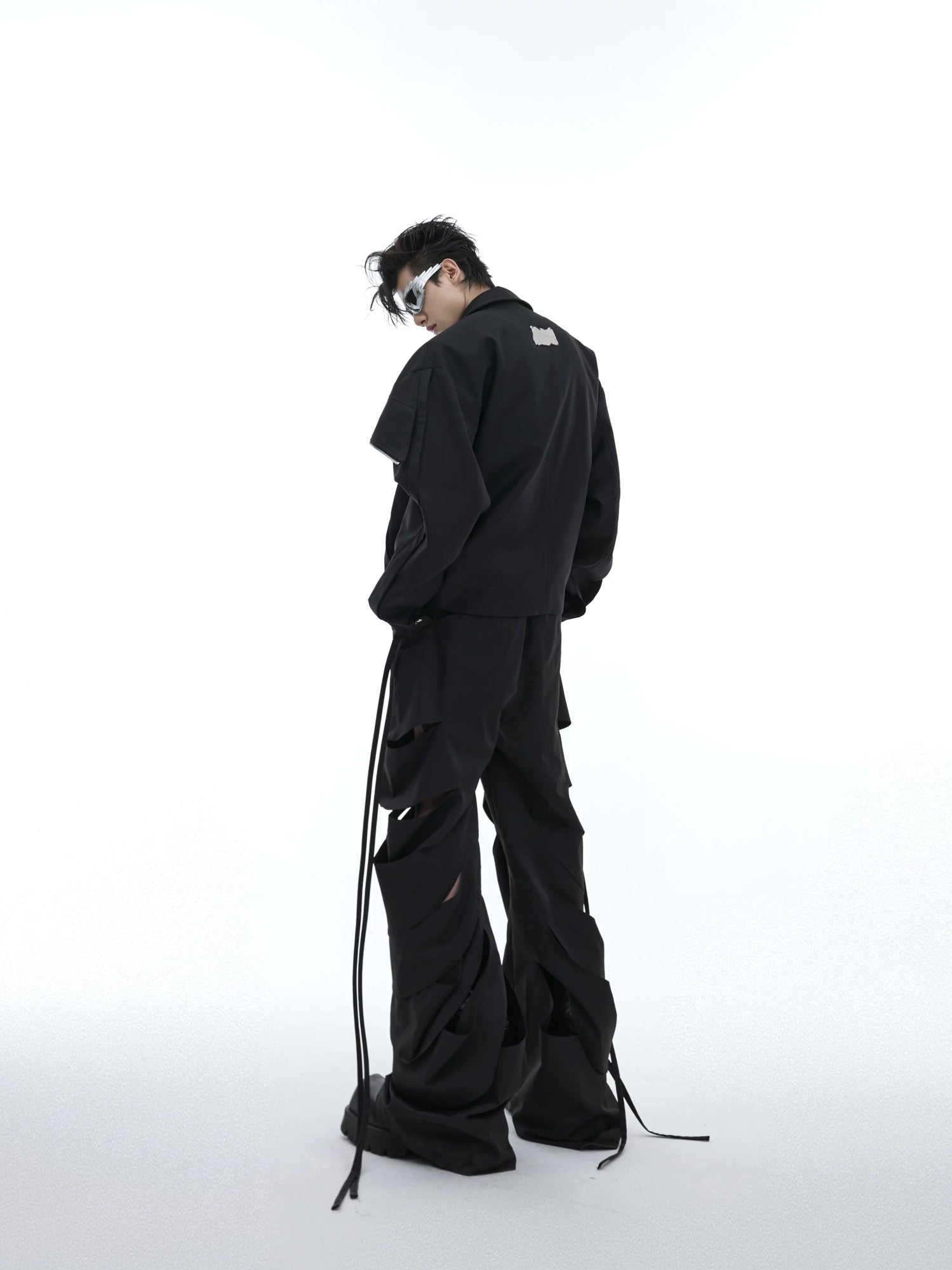 Full body shot of model wearing deconstructed flare cargo pants