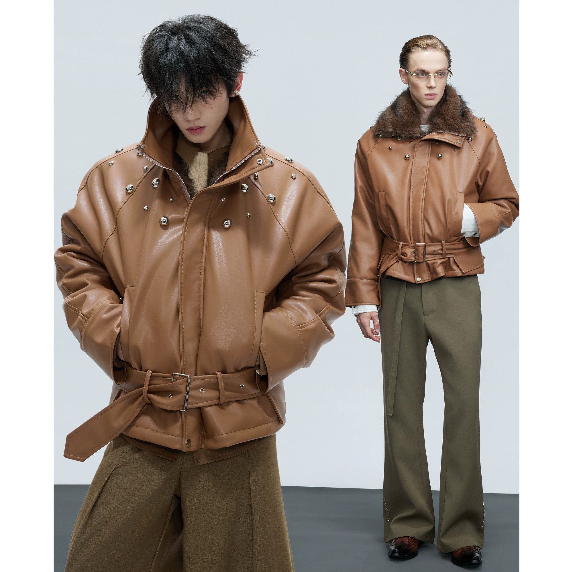 Close-up of metal pearl and stud hardware on a white leather jacket