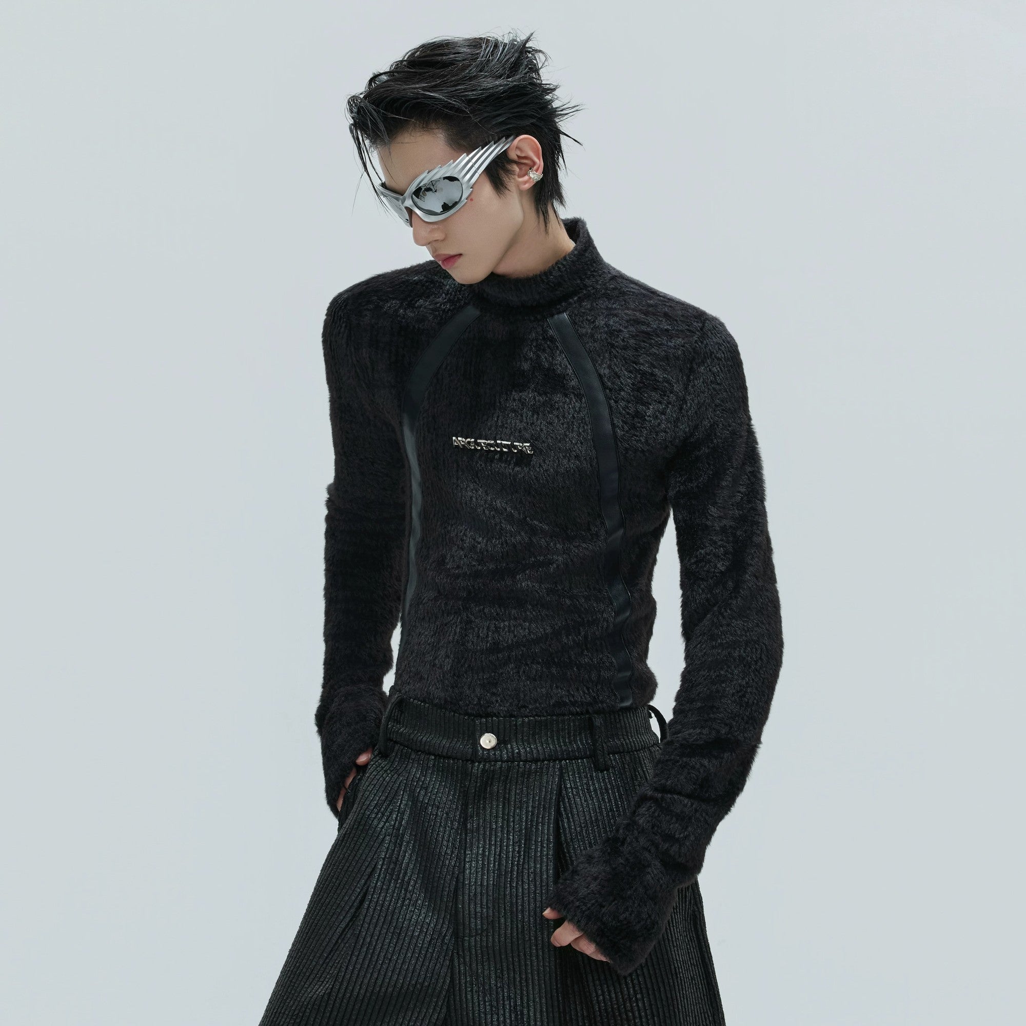 Front view of black deconstructed plush mock neck top with leather accents