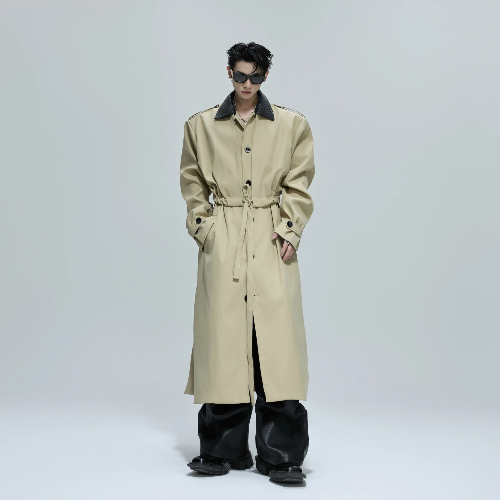 Close-up of the braided leather texture on a streetwear trench coat