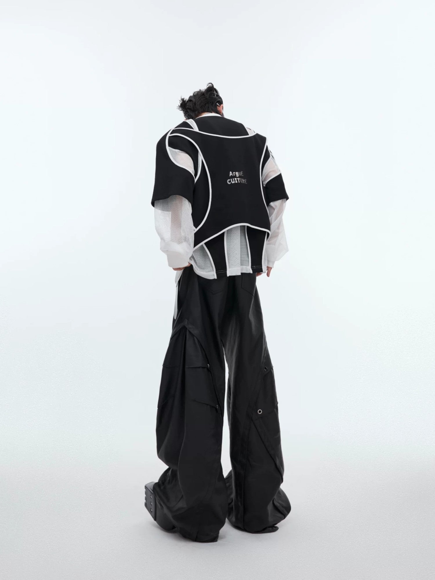 Model wearing oversized deconstructed sweatshirt with sharp shoulder pads