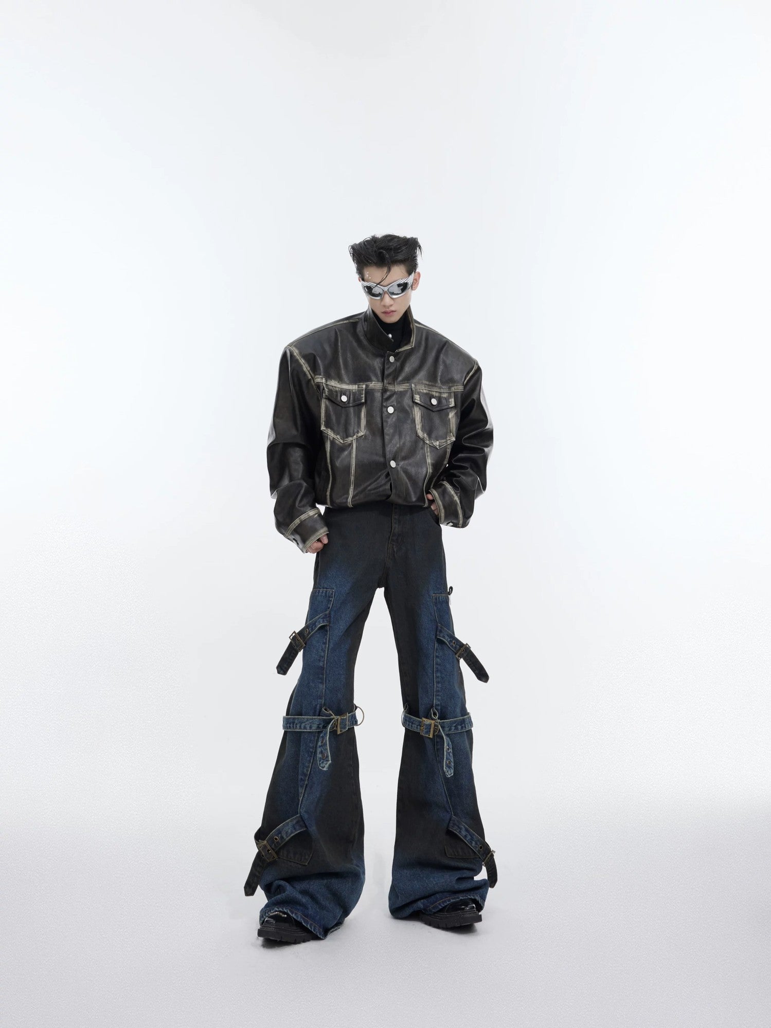 Back view of loose fit flare jeans featuring utility pockets and distressed edges.