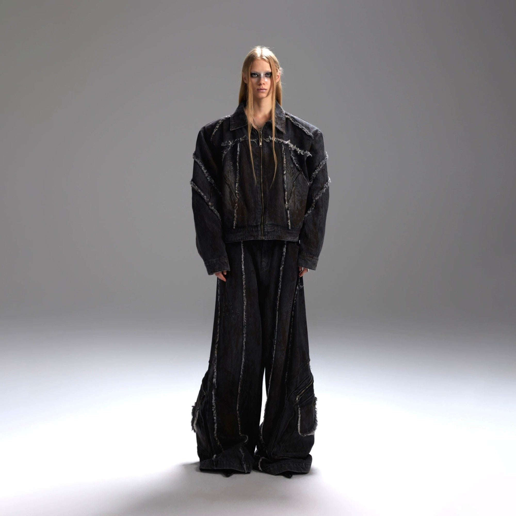 Full view of the deconstructed black denim jacket and cargo pants set.