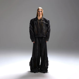 Full view of the deconstructed black denim jacket and cargo pants set.