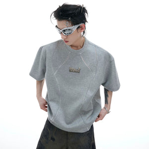 Close up of matte oxidized metal brand logo on the chest