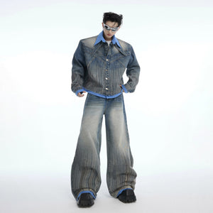 Close up of a blue deconstructed denim jacket with faux layered details.