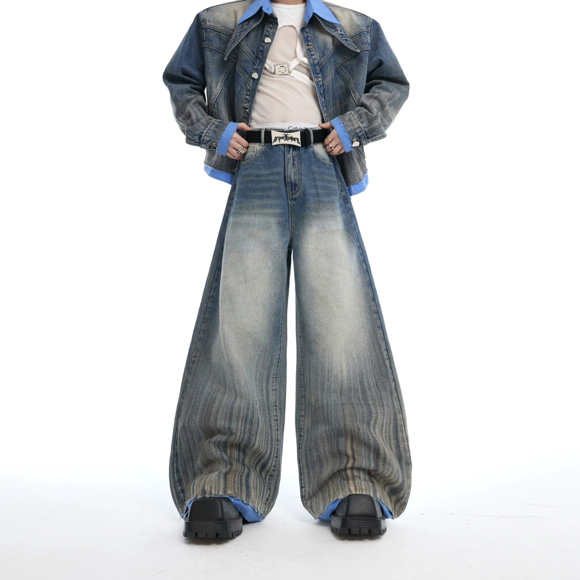 Male model wearing a full deconstructed denim jacket and pants set.