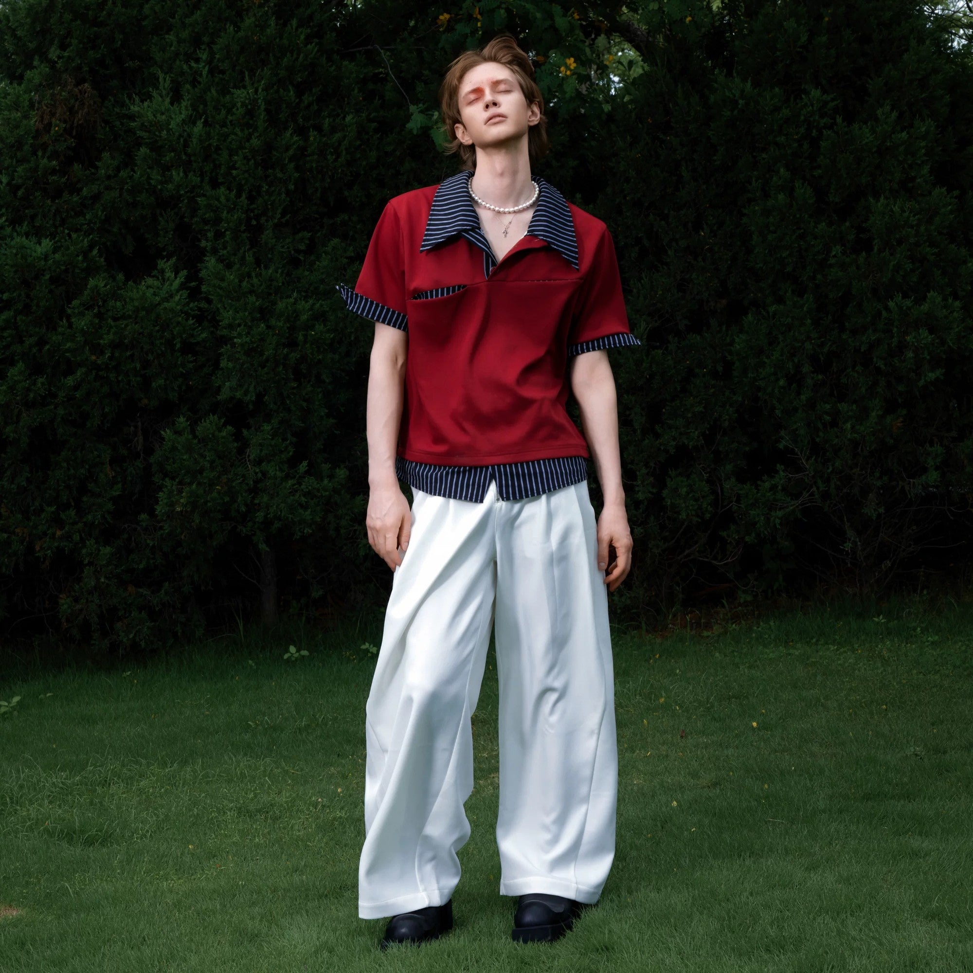 Street style model wearing the black deconstructed layered polo tee