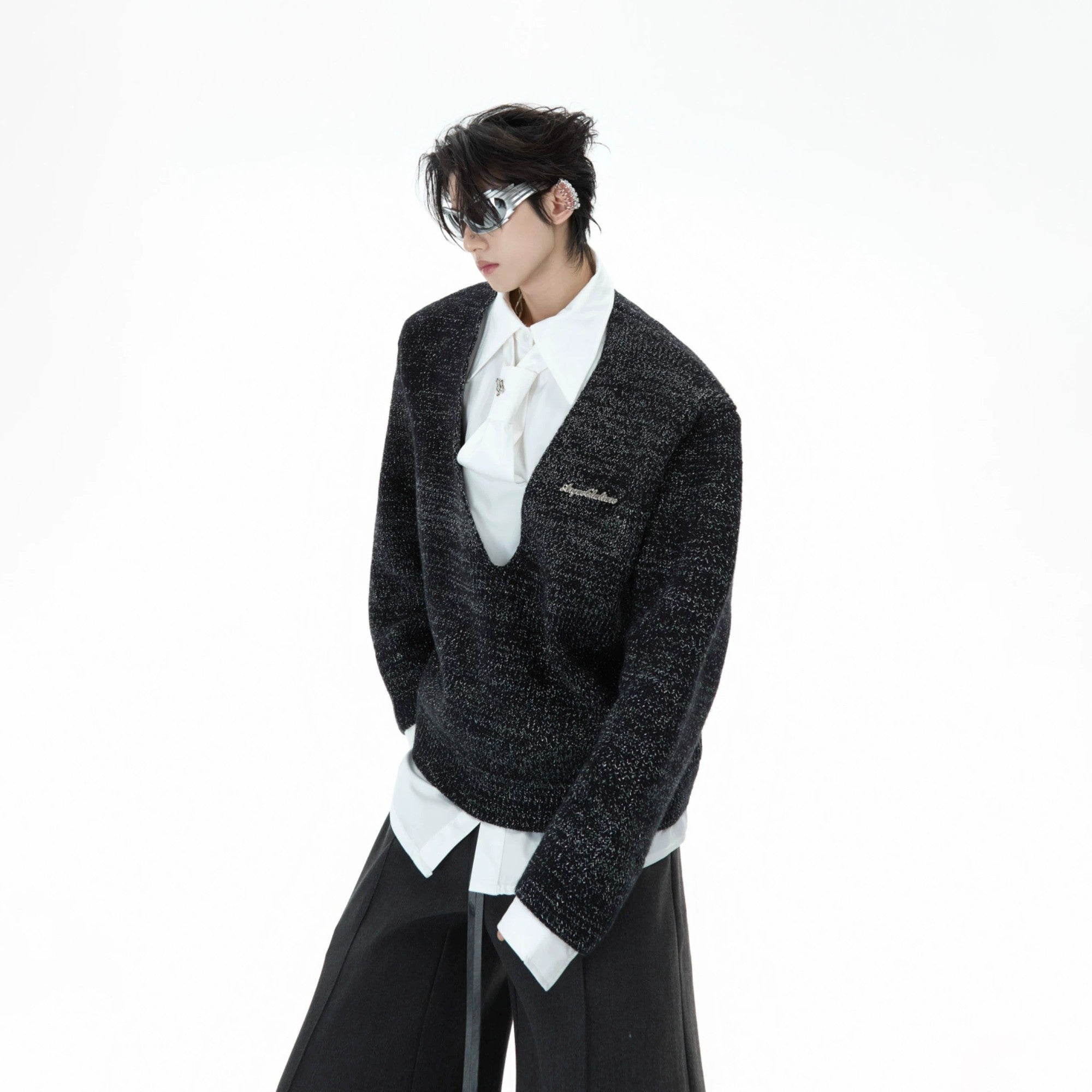 Front view of a grey oversized sweater with a built-in tie and shirt collar.