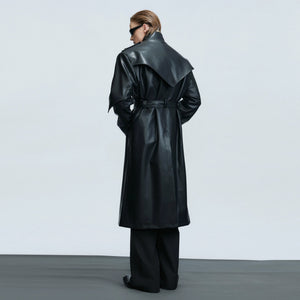 Model wearing a cinched waist deconstructed leather trench coat
