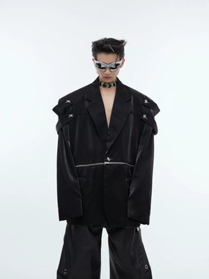 Close-up of split shoulder design and metallic accents on a black blazer