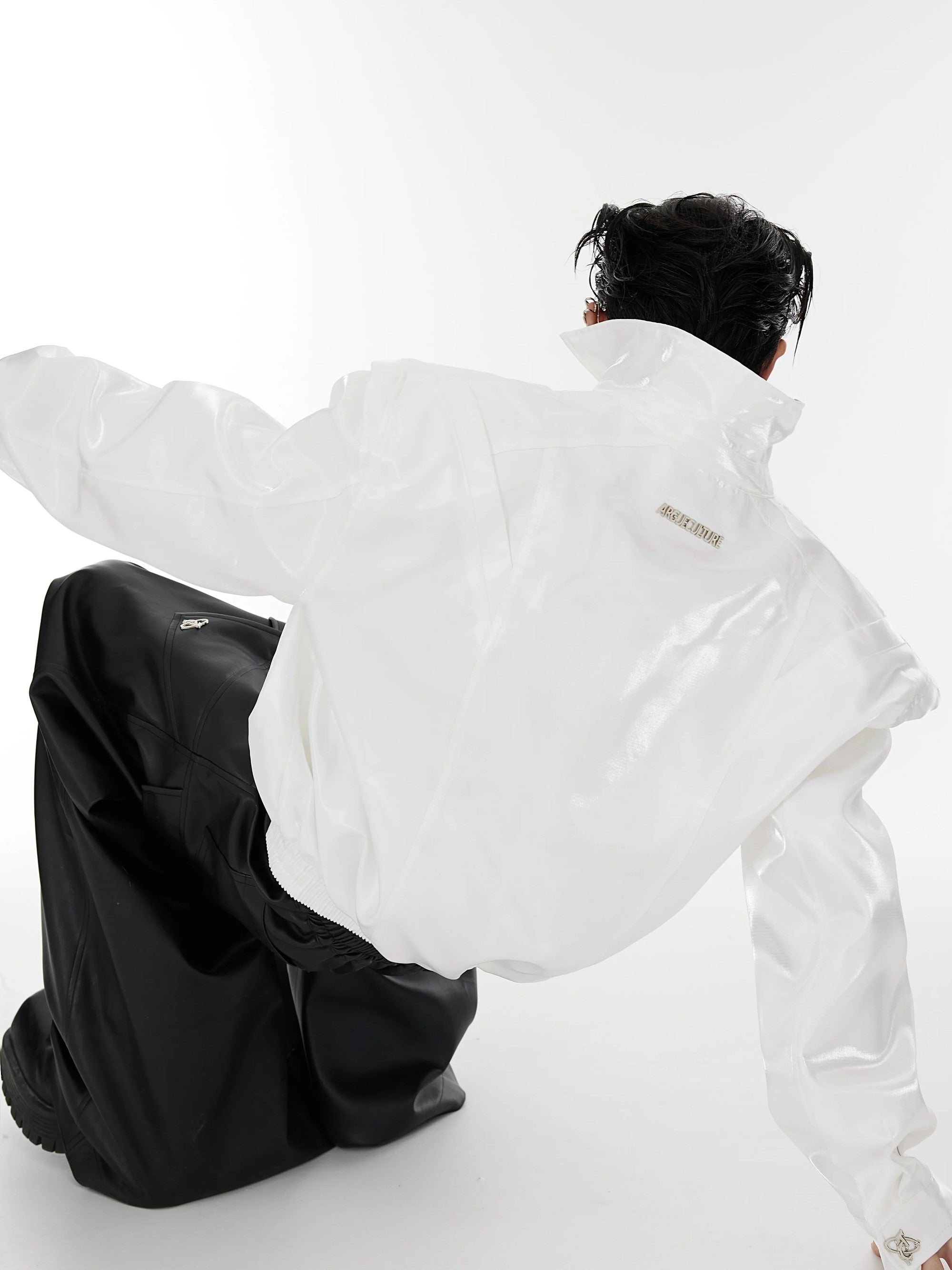 White liquid shimmer cropped jacket styled in a streetwear setting