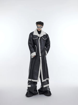 Front view of black deconstructed long shearling coat with pleated details