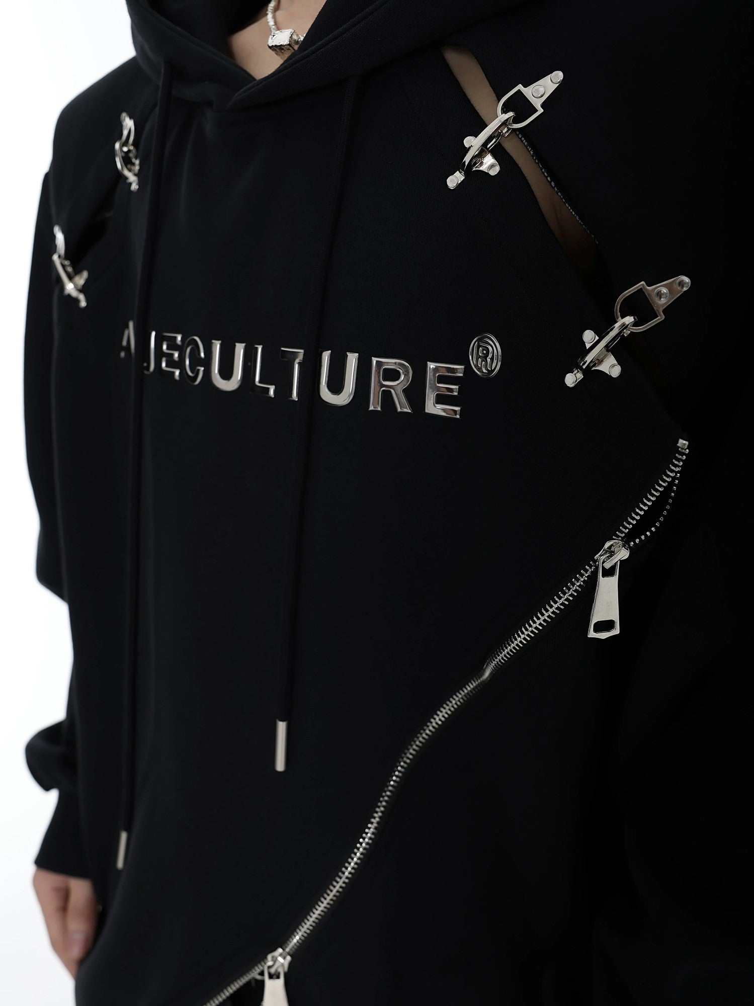 Close-up of heavy-duty metal airplane buckle hardware on cotton hoodie.