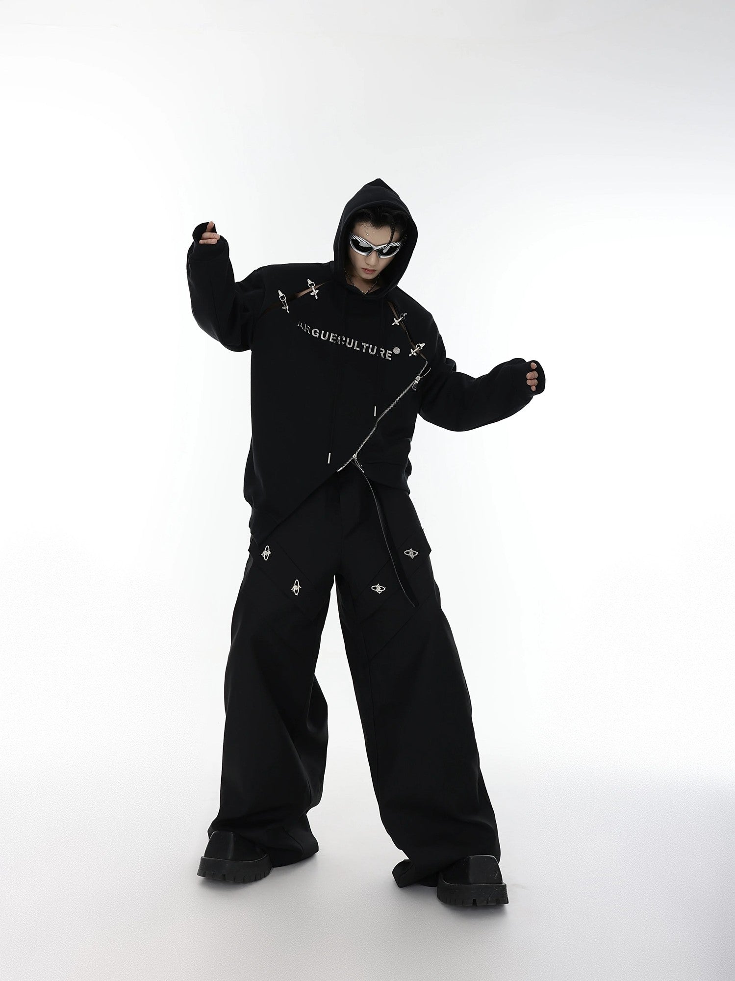 Lifestyle shot of a model wearing the deconstructed buckle hoodie in a city setting.
