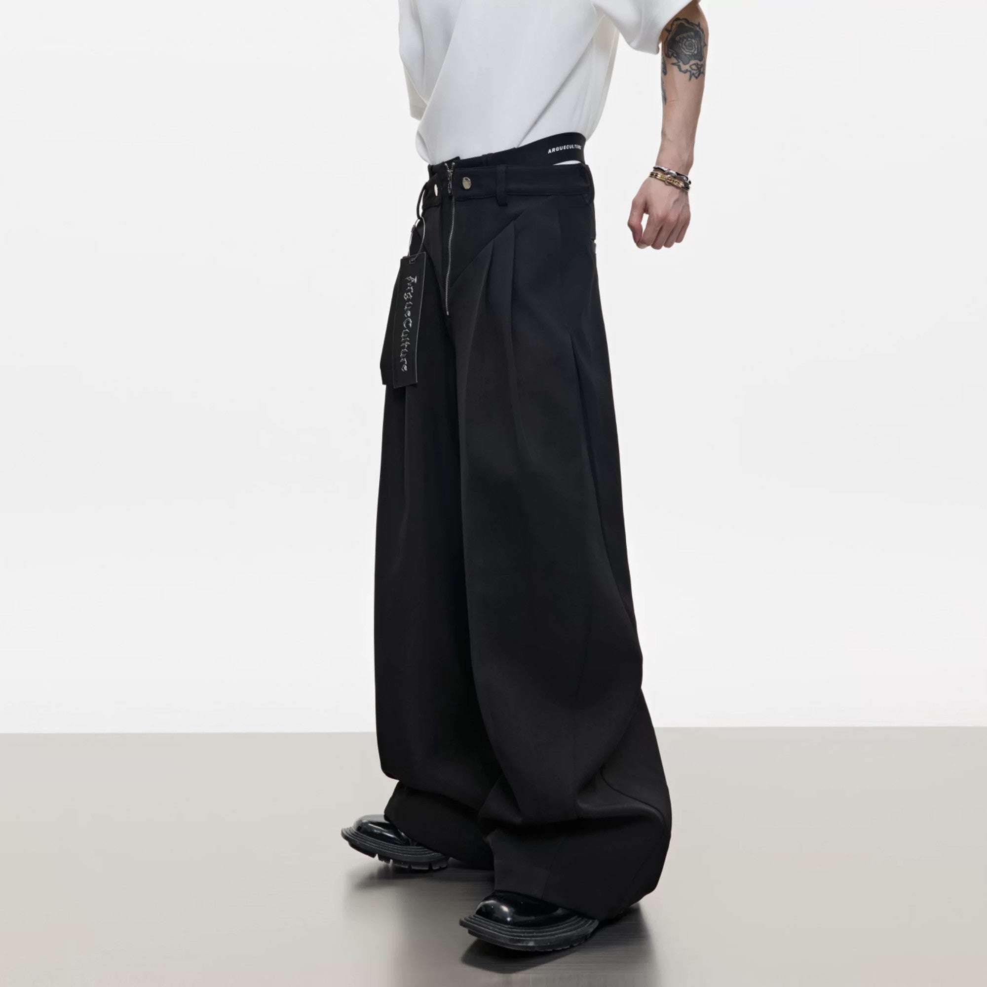 Model wearing white deconstructed baggy pants in a street setting