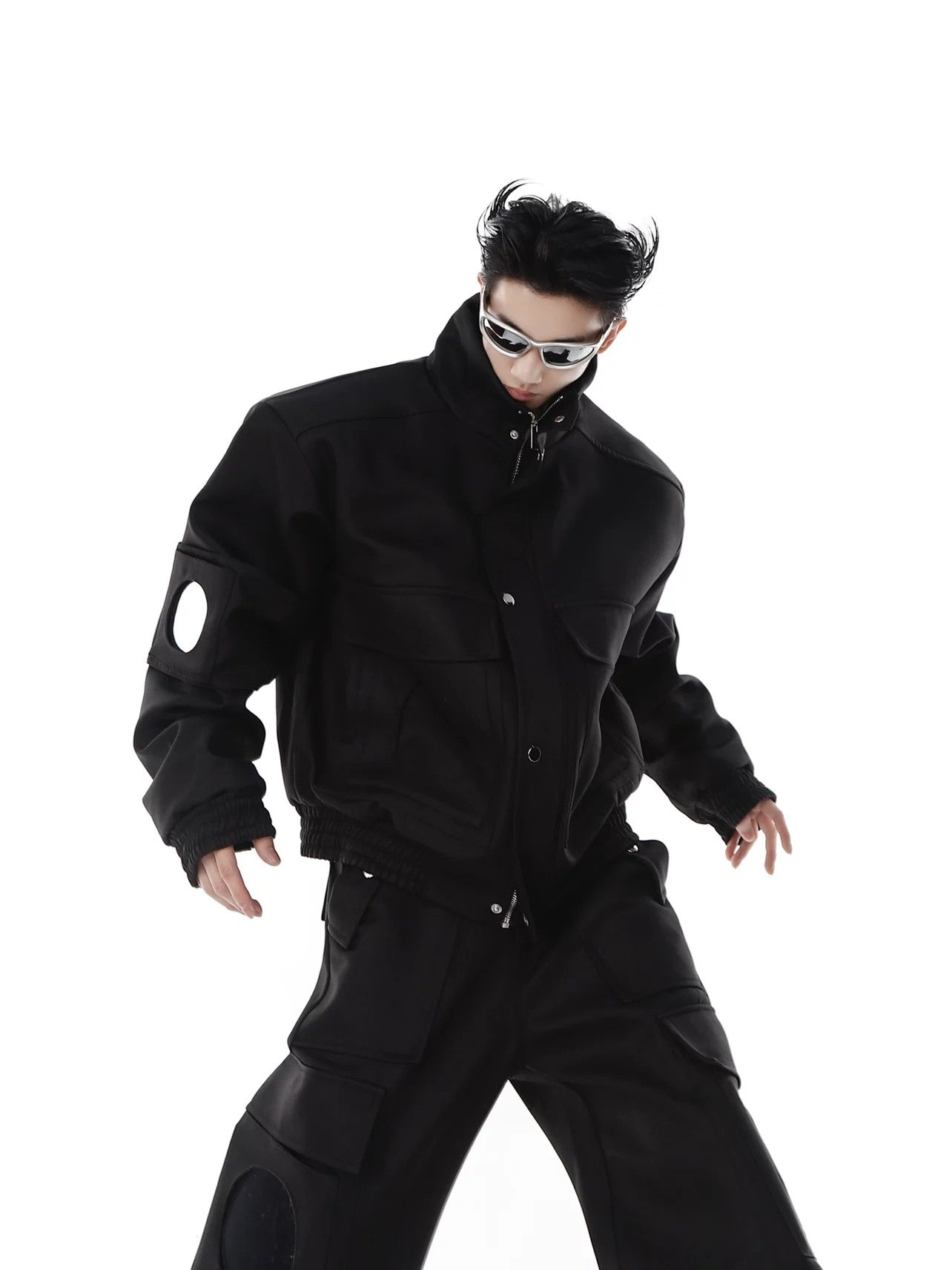 Close-up of the structured padded shoulders and high-neck collar design.