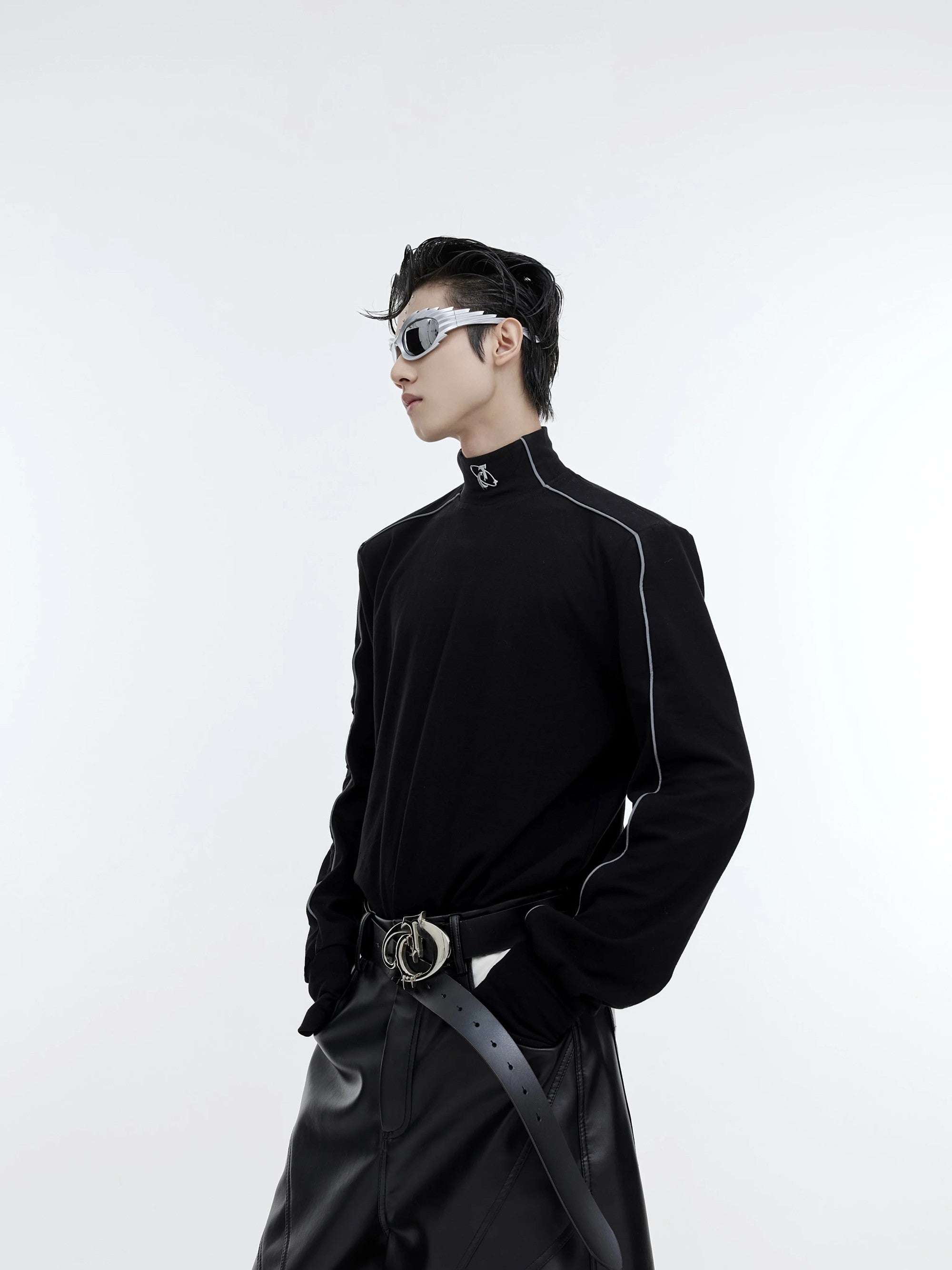 Front view of black deconstructed mock neck top with reflective strips