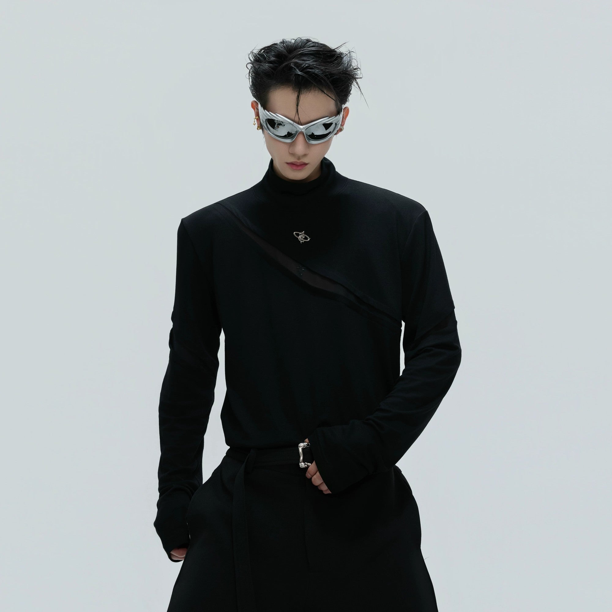 Close-up of silver metal logo on black cotton base layer