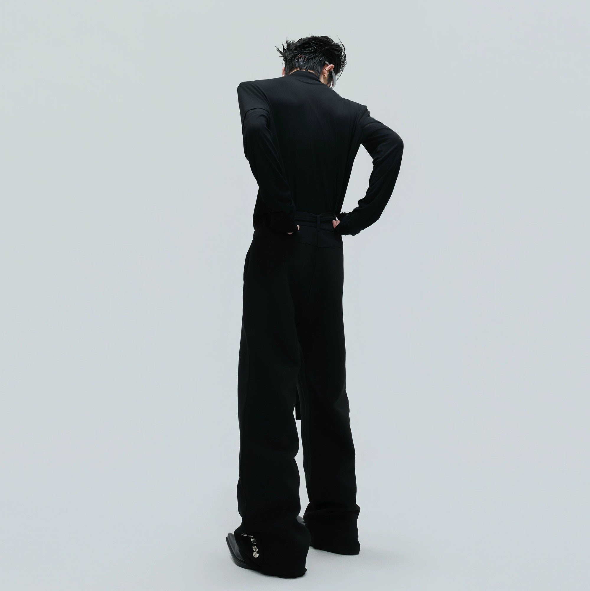 Model wearing deconstructed mock neck tee with techwear accessories