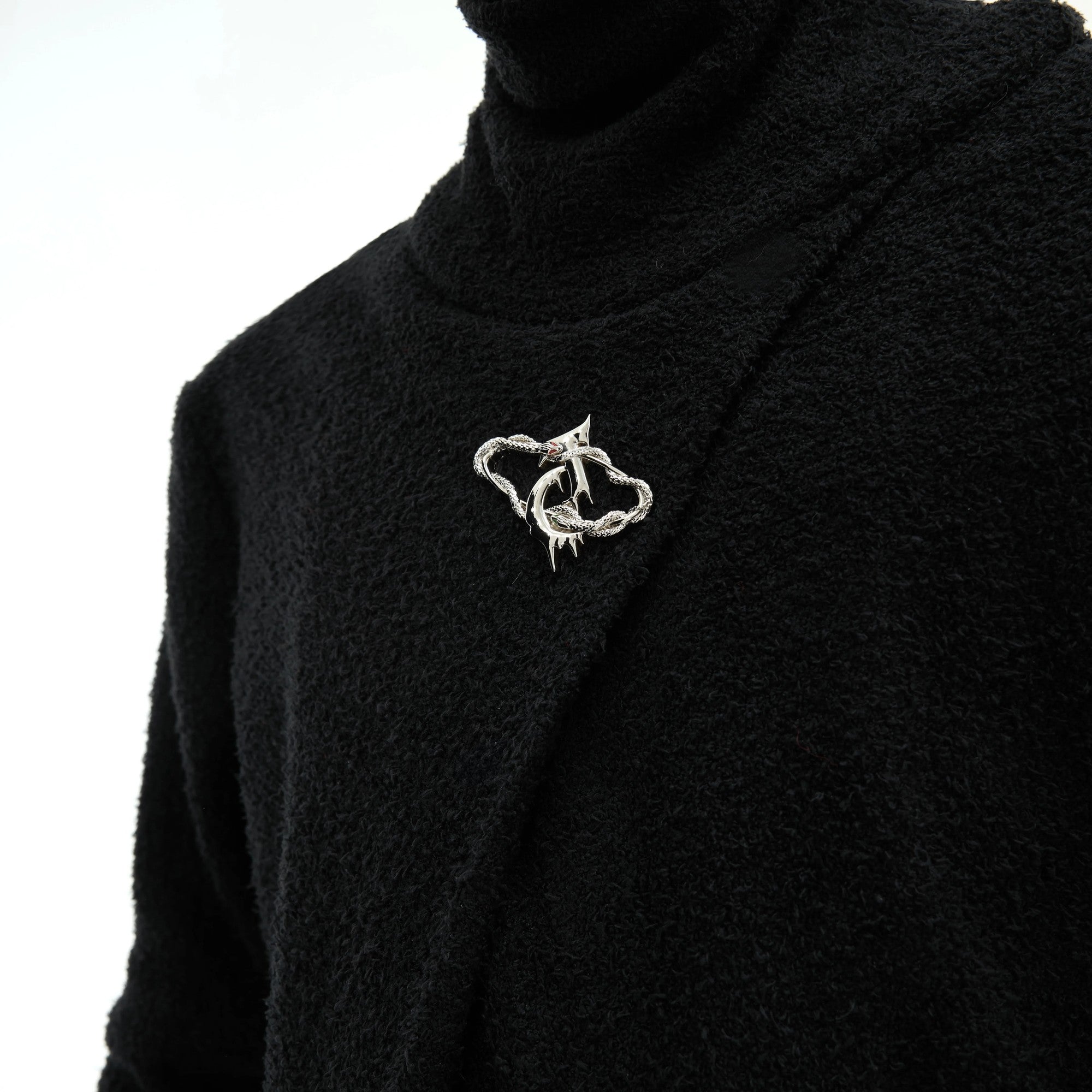 Close up of high-end metal logo branding on the mock neck collar