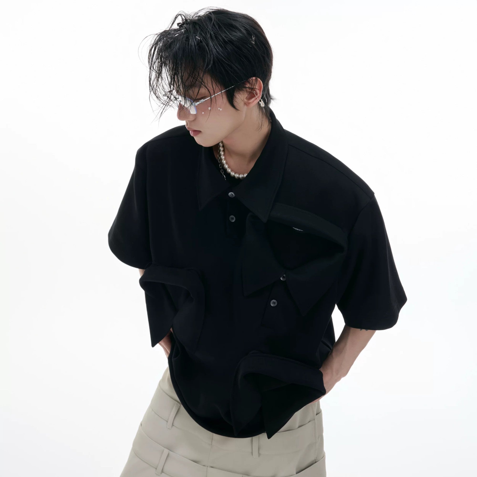 Male model wearing white deconstructed polo shirt in urban setting