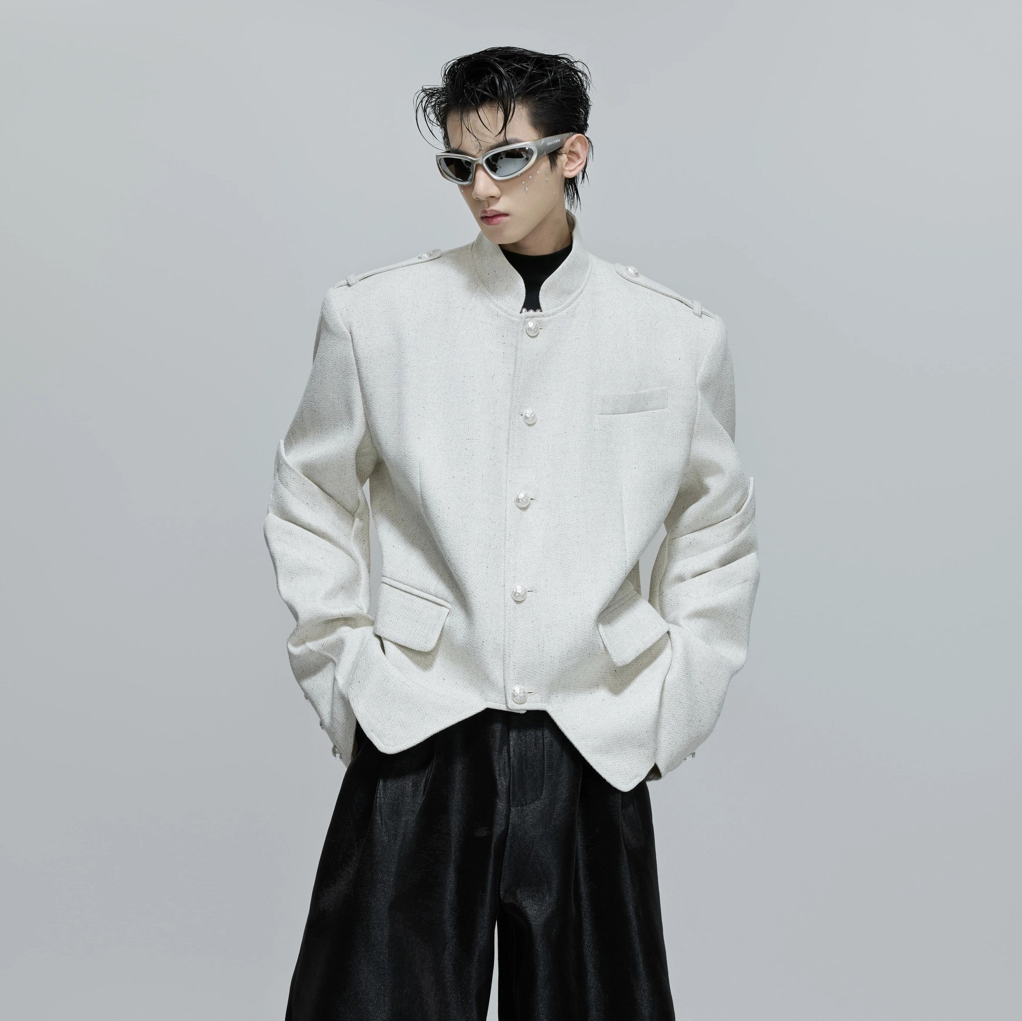 Front view of the deconstructed stand collar jacket in black streetwear style