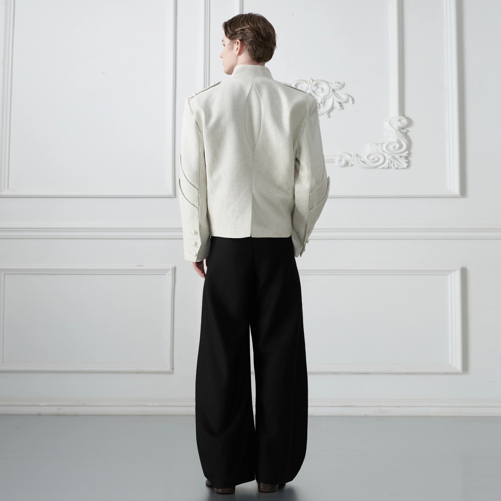 Model wearing the oversized deconstructed jacket in an urban setting