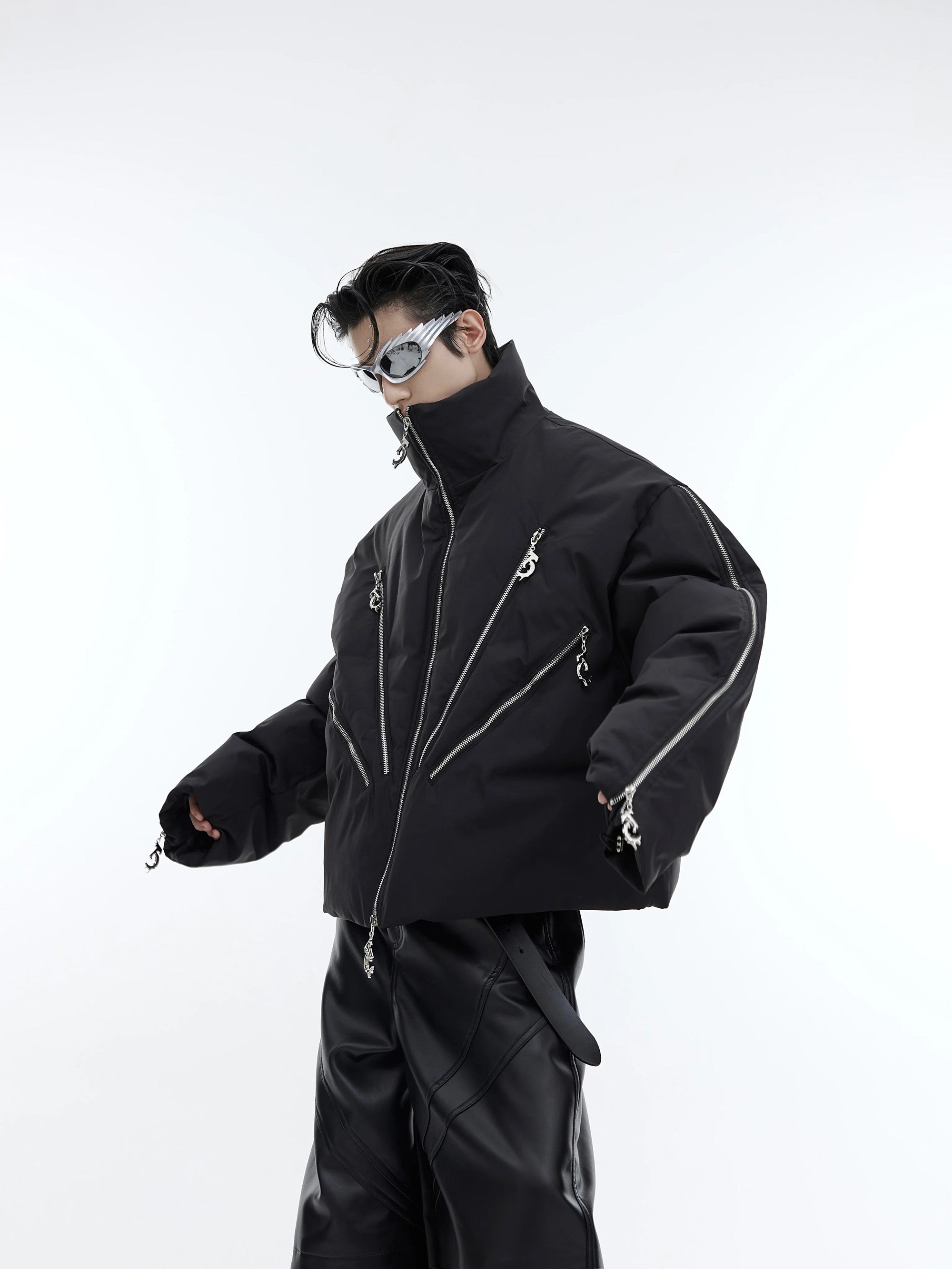 Front view of black deconstructed multi-zip puffer jacket for men