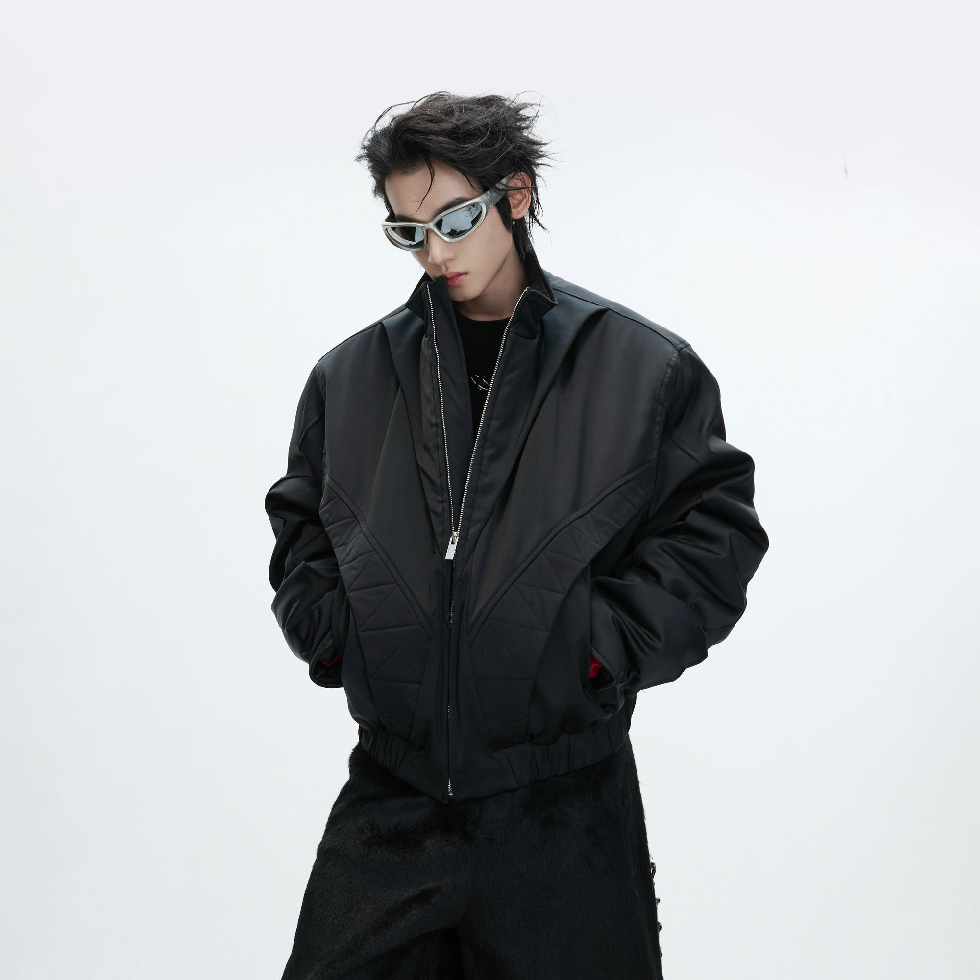 Lifestyle shot of a model wearing the loose fit deconstructed bomber