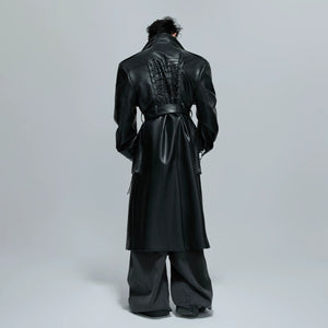 Close-up of 3D patchwork and strap design on a black leather coat