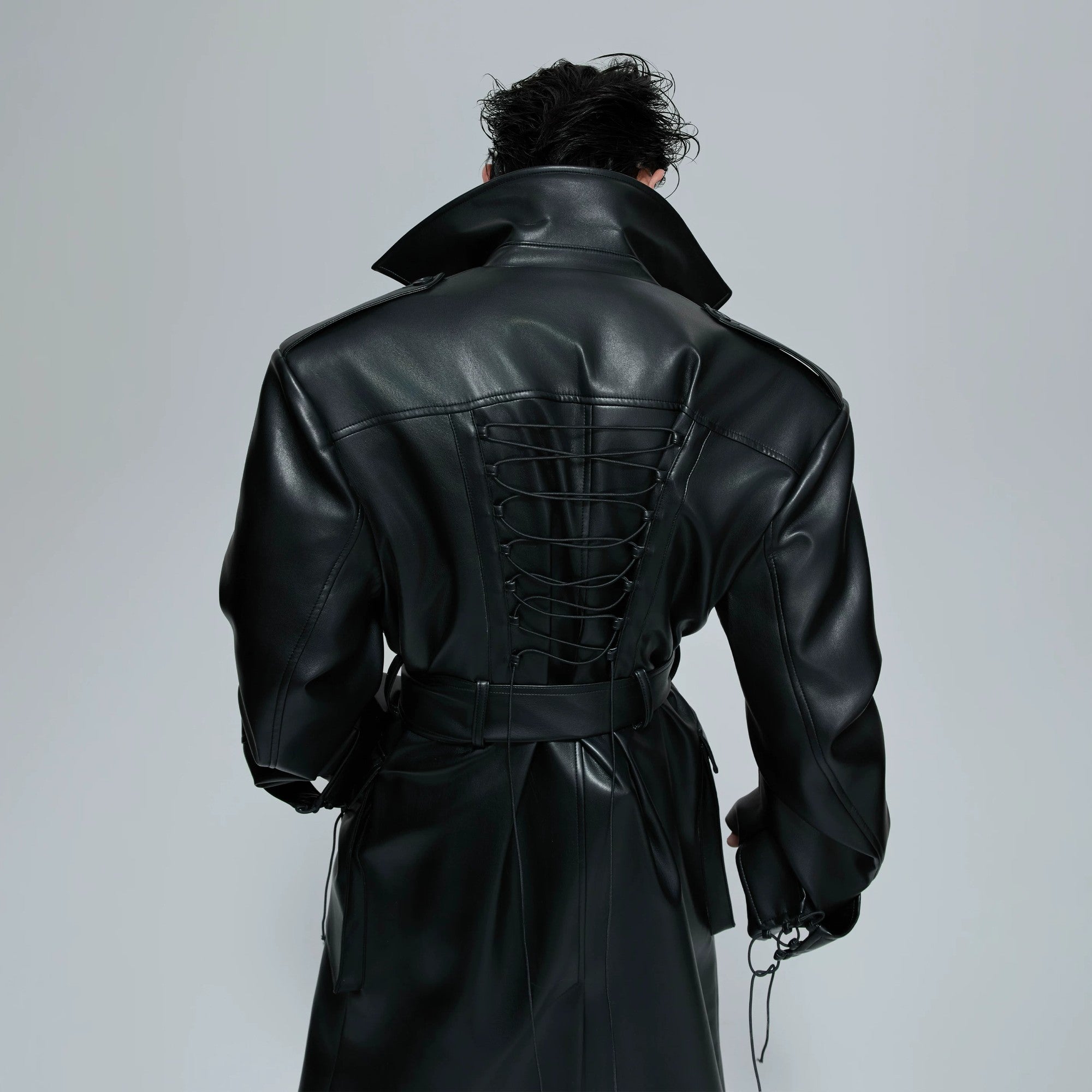 Back view of the long-line deconstructed leather jacket showing seam details