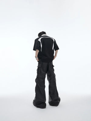 Close-up of the metal design accents on the collar of a streetwear polo.