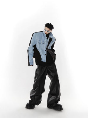 Back view of a blue patchwork denim jacket showing the oversized silhouette.