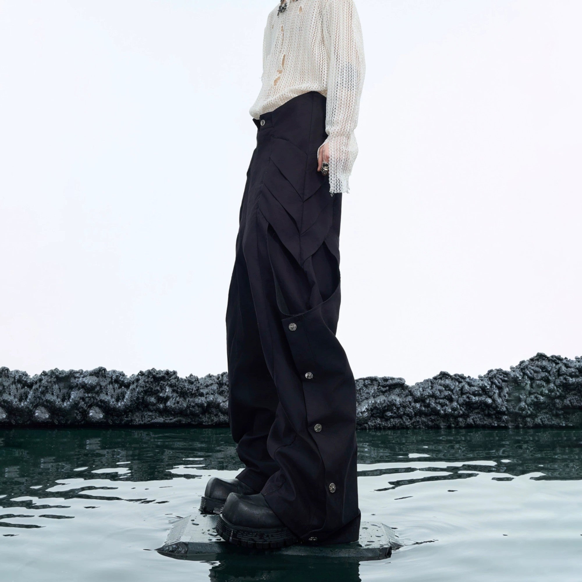 Model wearing black deconstructed cargo pants with chunky sneakers