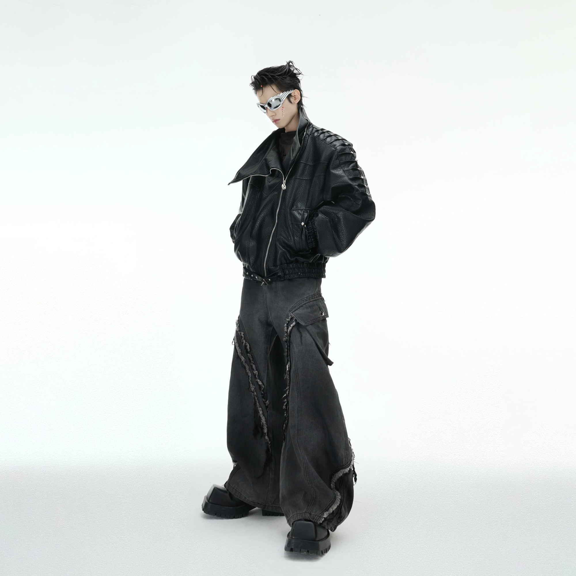 Model wearing a loose fit rivet moto jacket in an urban street setting