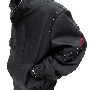 Close-up of matte alloy rivets and textured cotton fabric