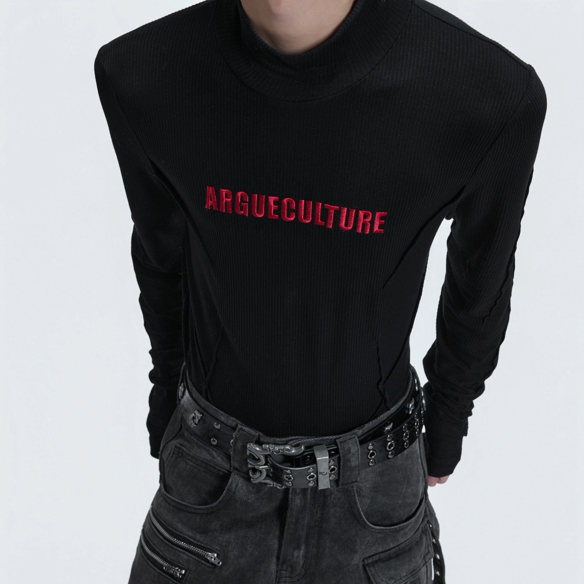 Male model wearing gray deconstructed turtleneck in an urban setting