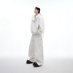 Model wearing white deconstructed wide-leg trousers in a street setting