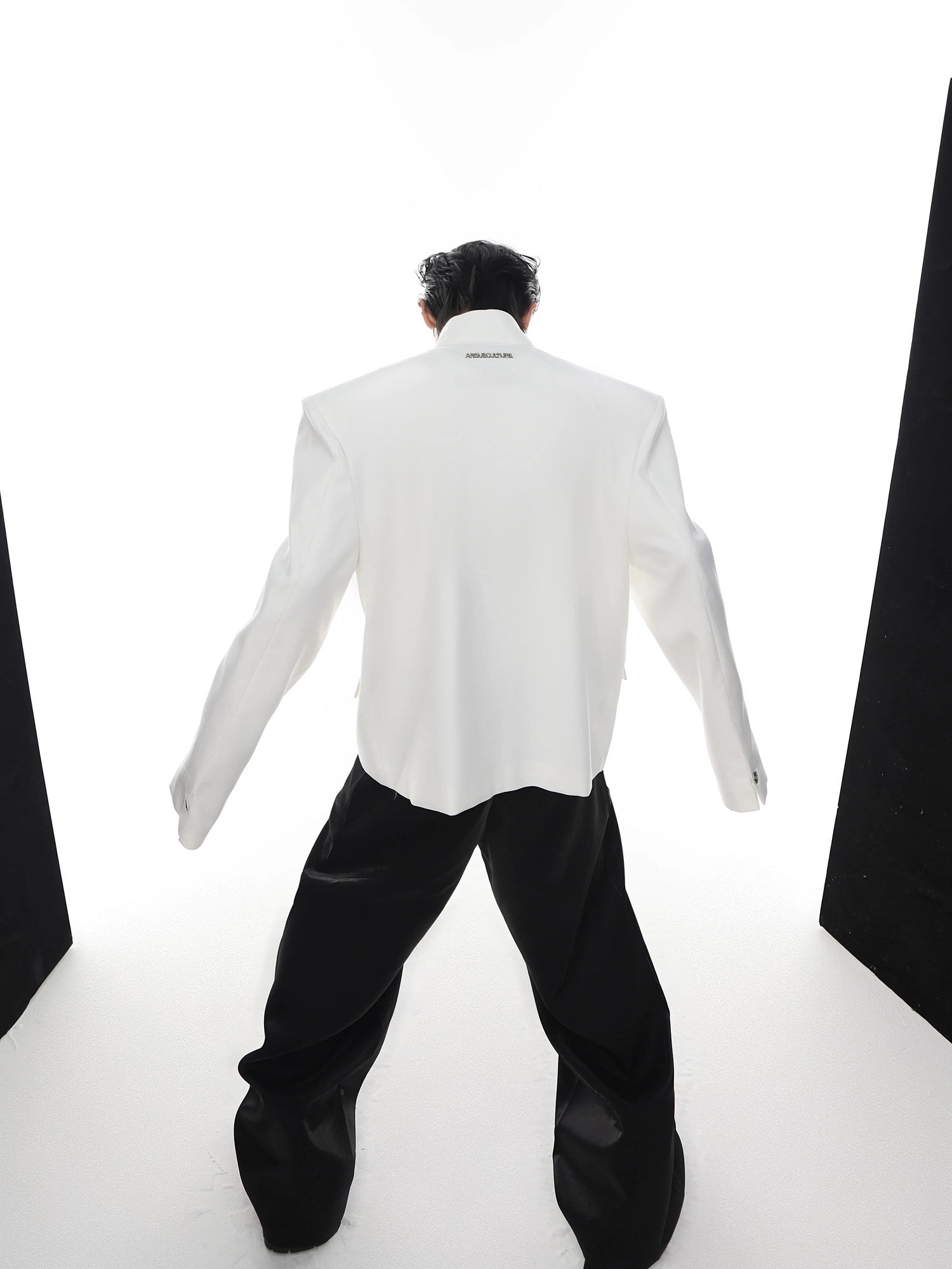 Detailed view of the stand collar and metal buckle styling on a blazer