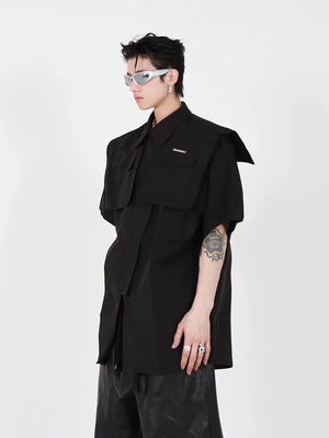 Front view of black deconstructed short sleeve jacket with metal accents