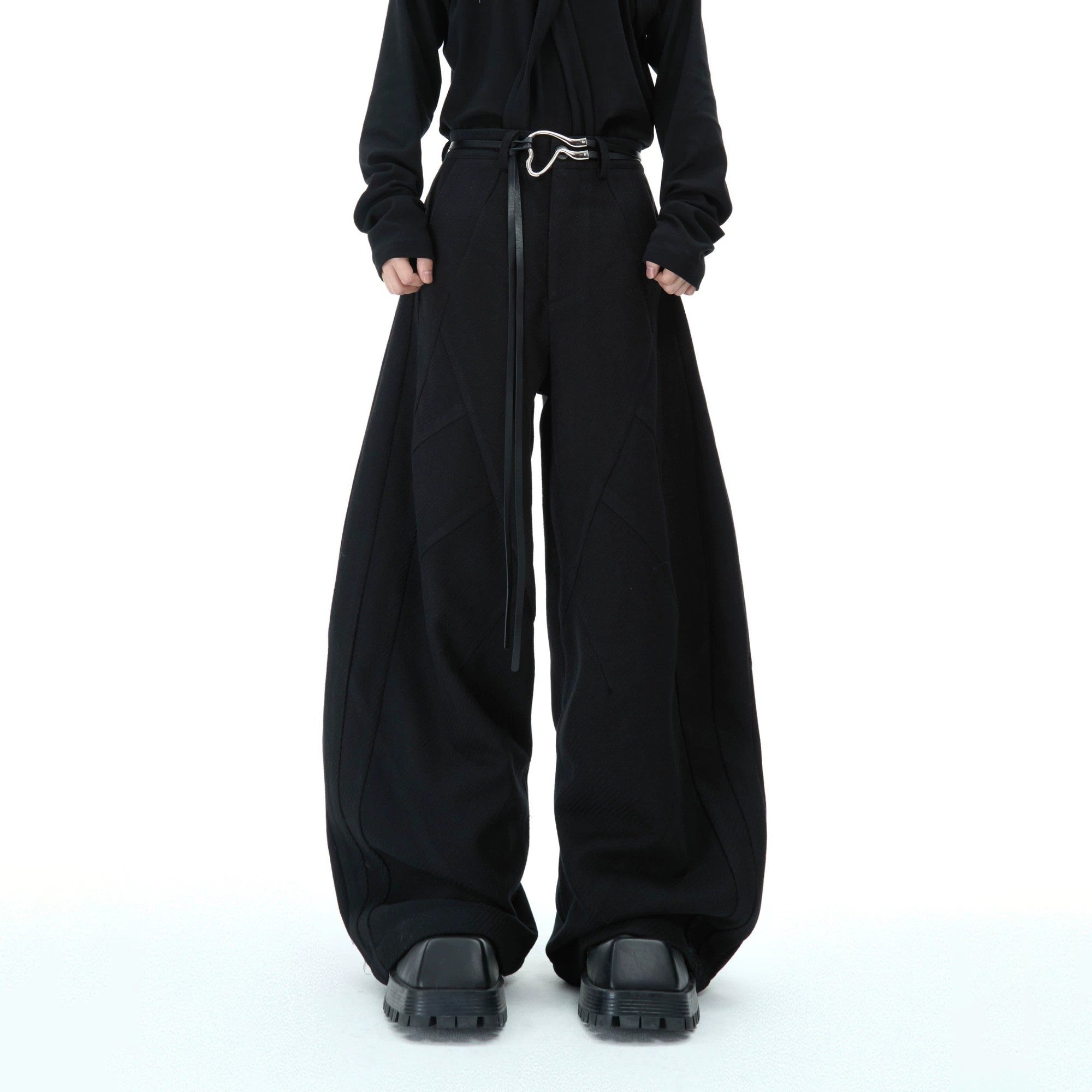 Front view of deconstructed red wide-leg trousers with 3D texture