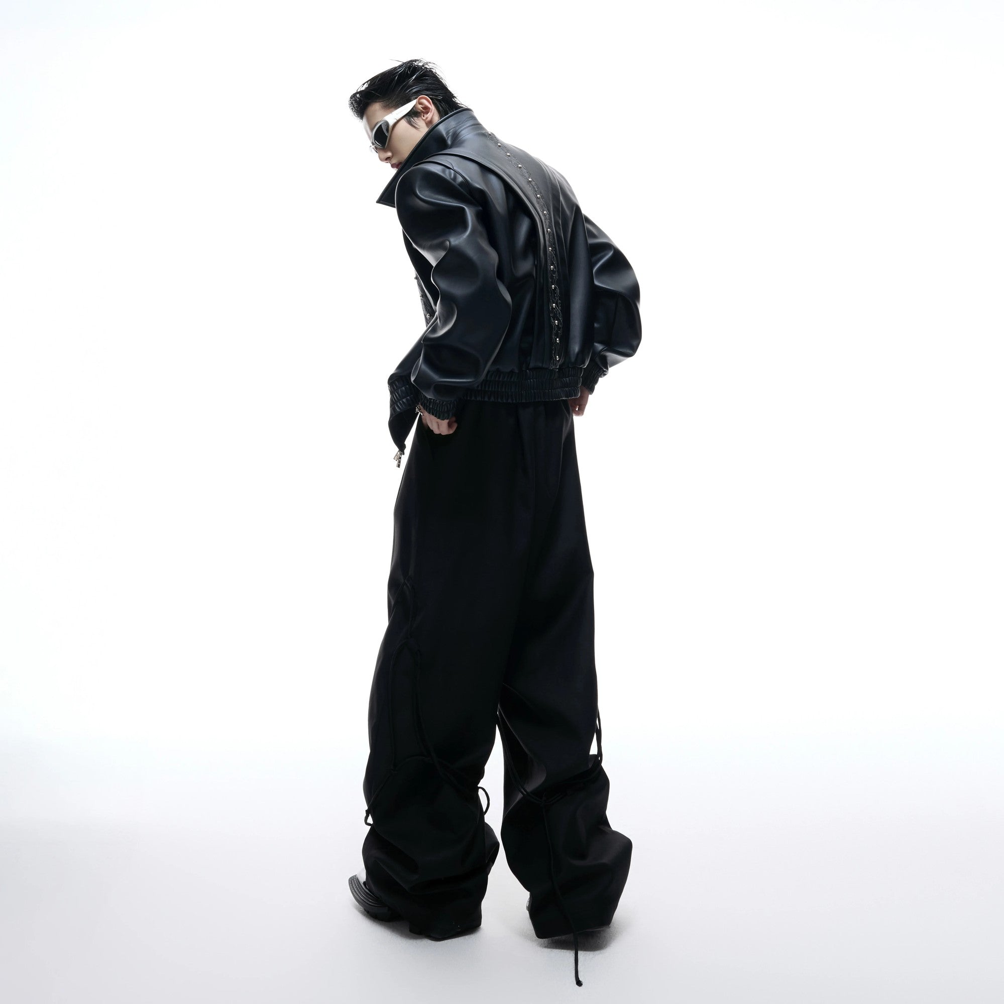 Back view showing the loose fit and deconstructed design of the jacket