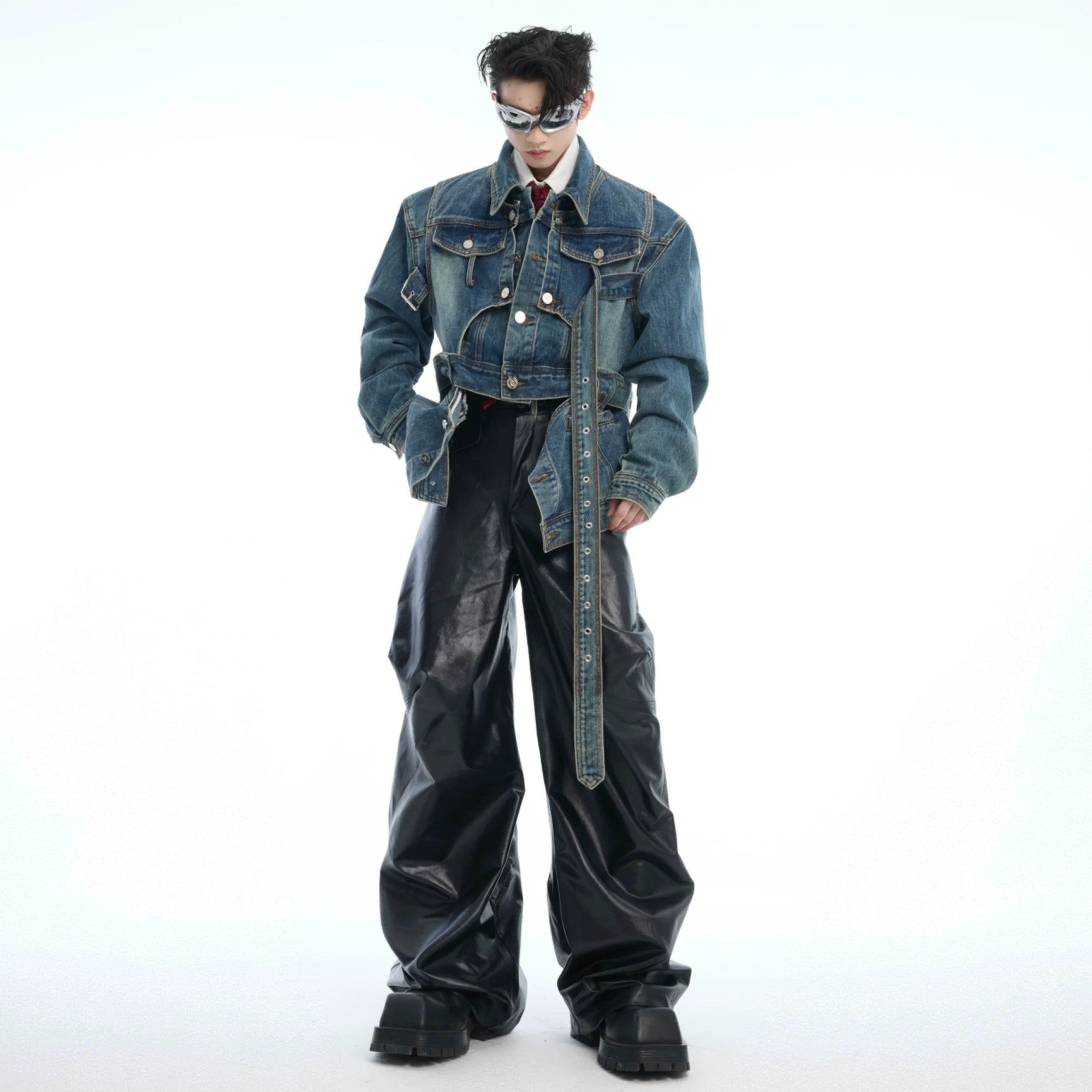 Model wearing a cropped deconstructed denim jacket in black