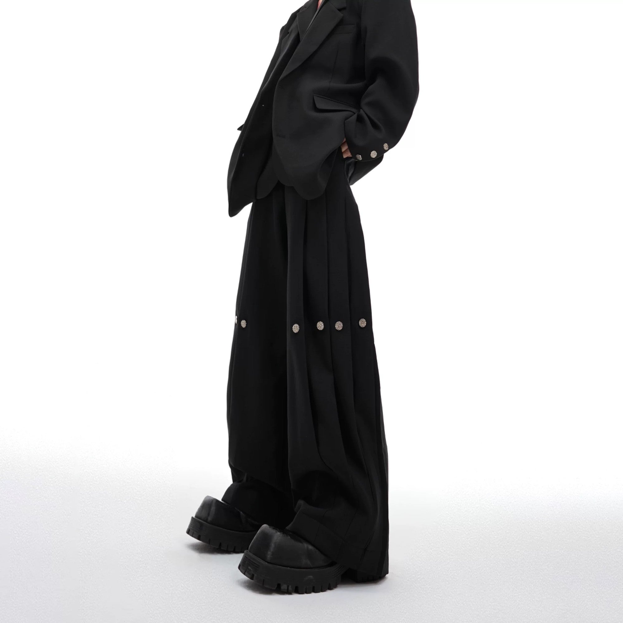Black deconstructed wide-leg pleated trousers with baggy fit