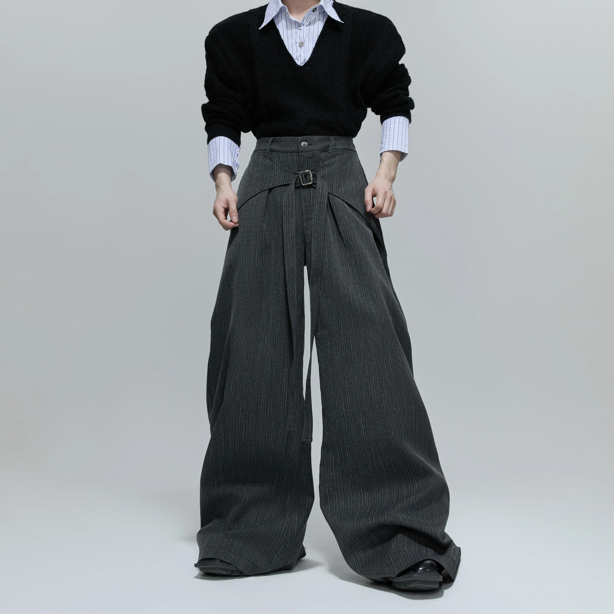 Front view of deconstructed gray wide-leg streetwear trousers