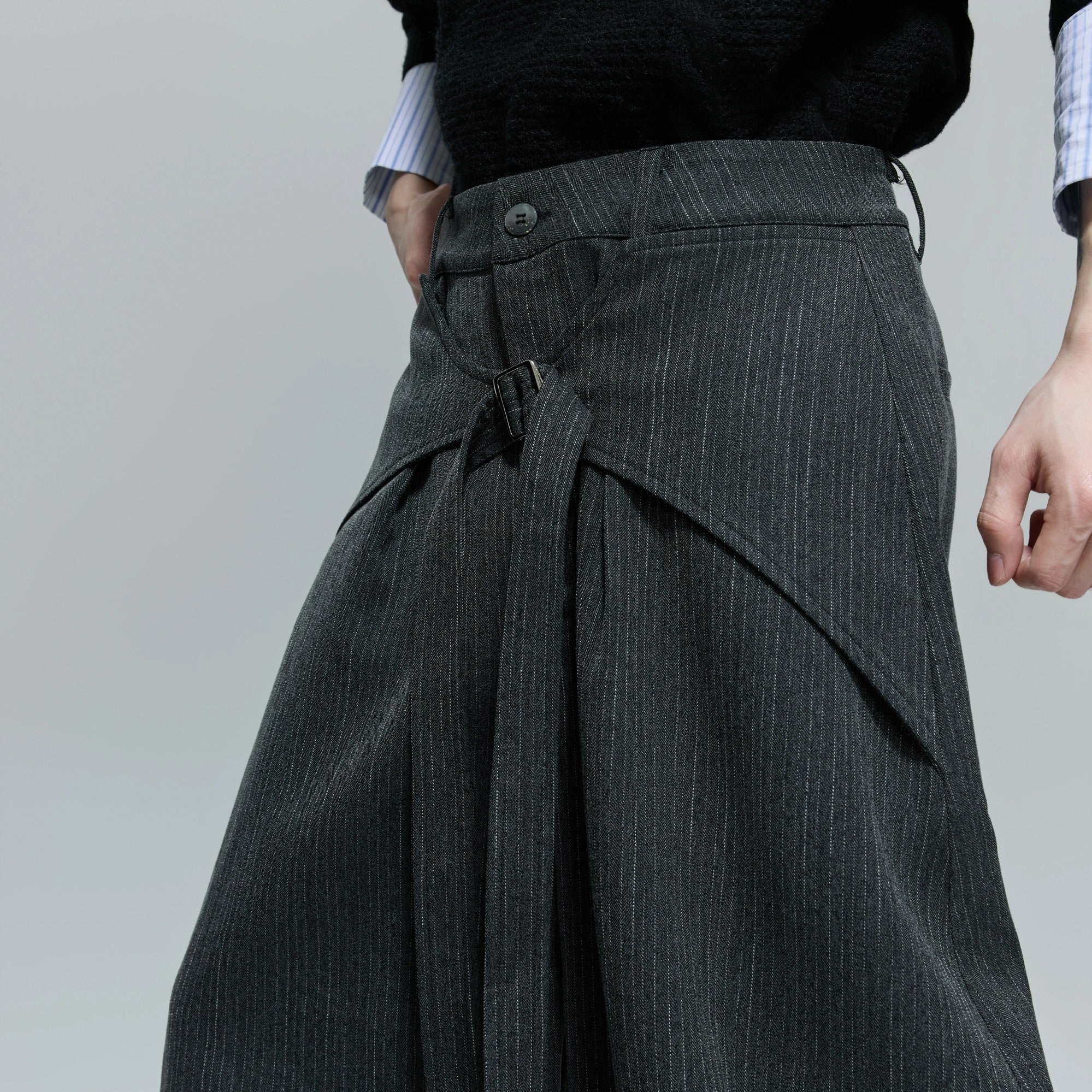 Side profile of loose fit deconstructed pants for men