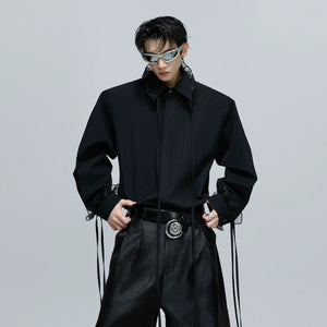 Close-up of detachable shoulder pad design on a streetwear shirt