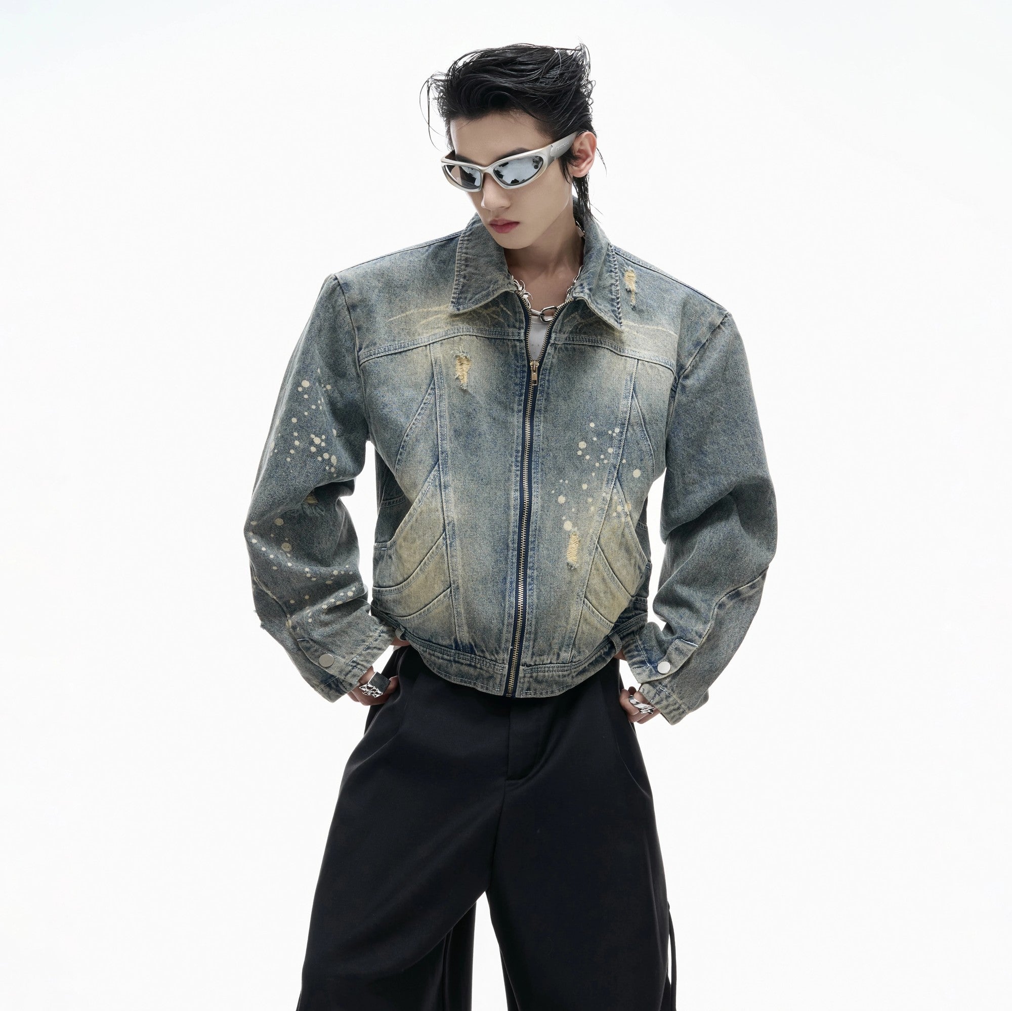 Front view of a blue distressed cropped denim jacket with burnout details