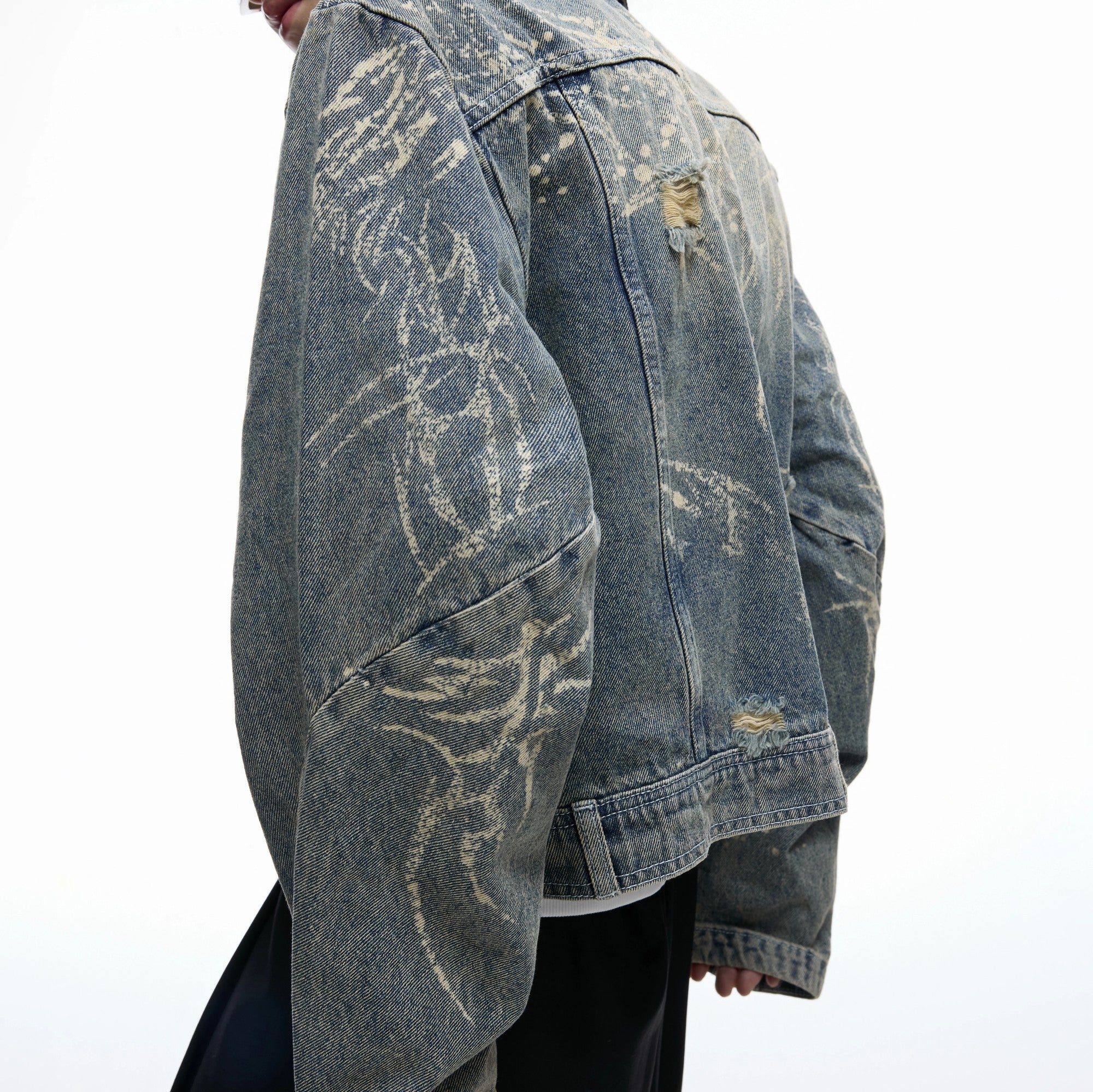 Model wearing a boxy fit cropped denim jacket in an urban setting